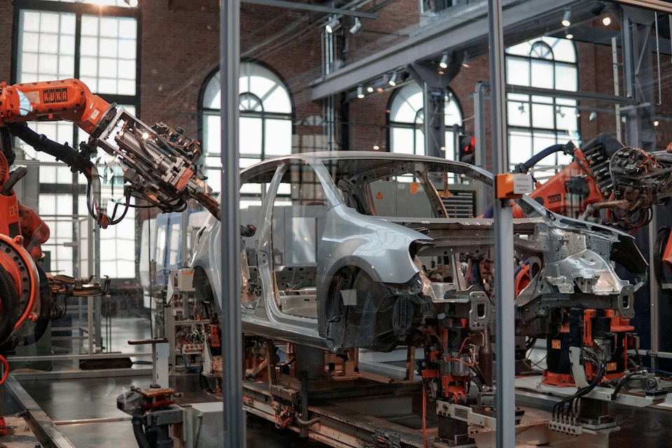 Vehicle assembly line with automated manufacturing equipment